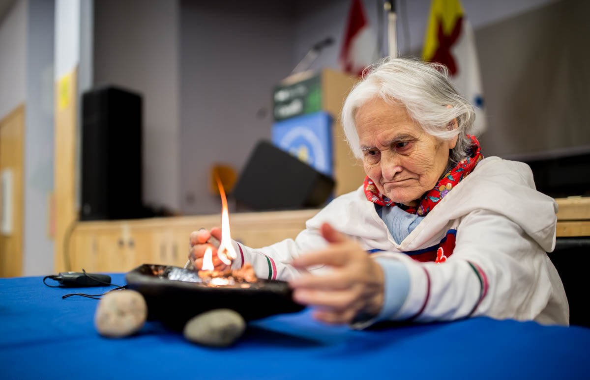 An Elder in Pond Inlet lights the qullik during the Tallurutiup Imanga/Lancaster Sound announcement. Photo (c) Martin Lipman/SOI Foundation