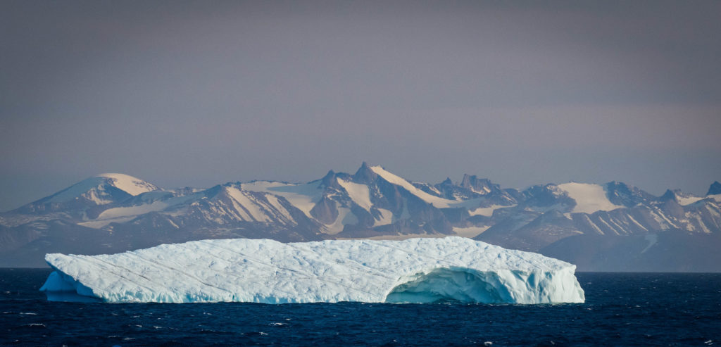 An iceberg glides past the coast of eastern Nunavut.
