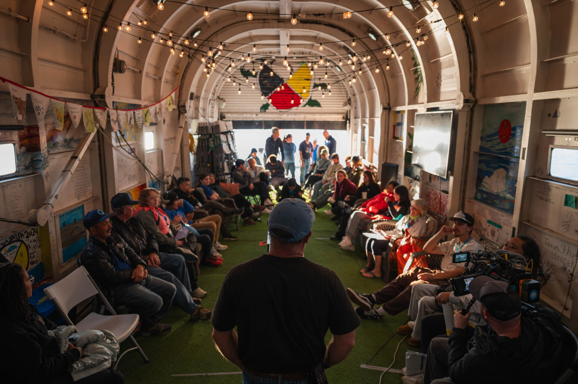 Expedition leader and SOI founder Geoff Green briefs the team on what to expect in the coming days in the hangar on the Polar Prince.